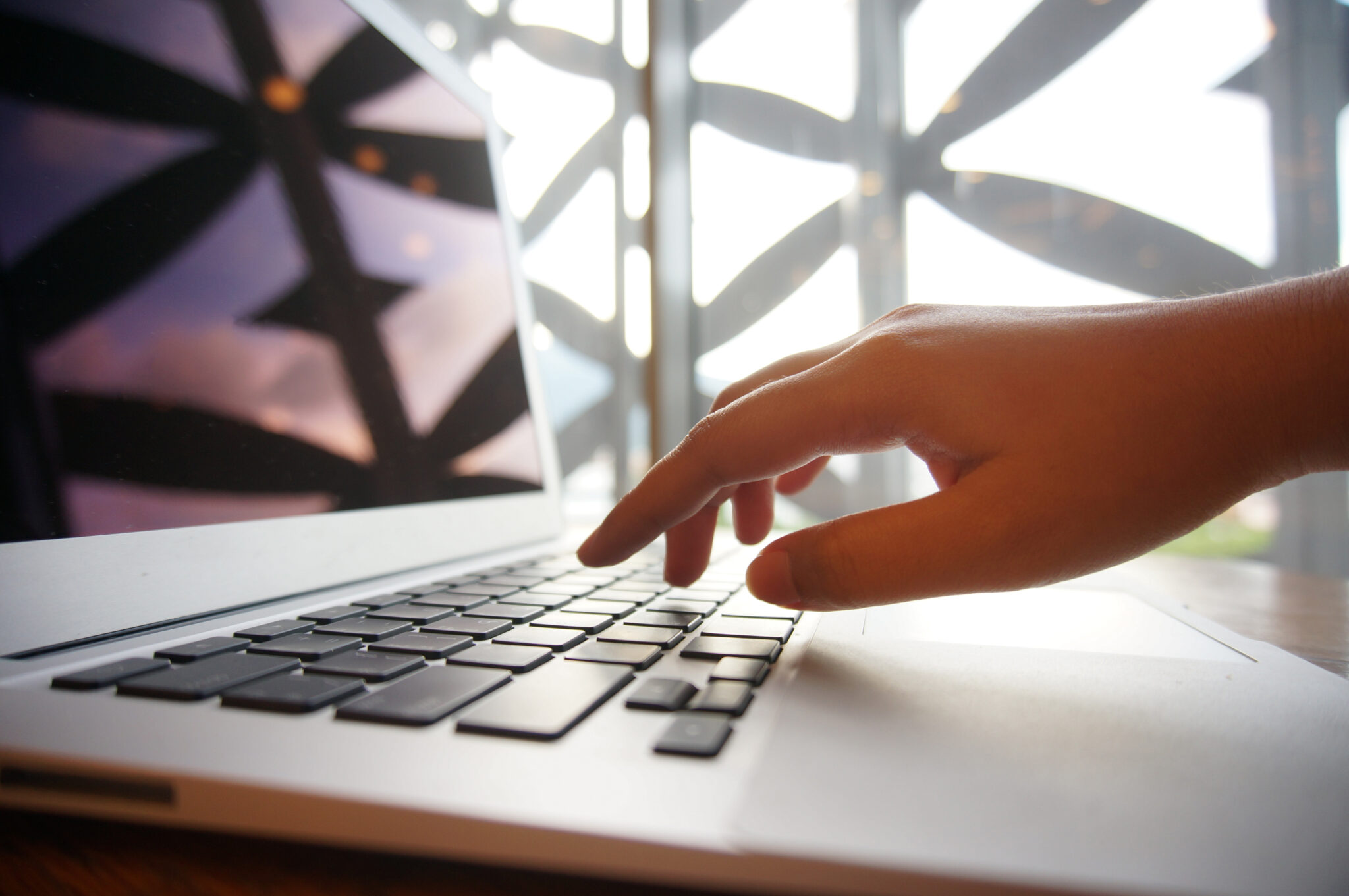 Working By Using A Laptop Computer On Wooden Table. Hands Typing